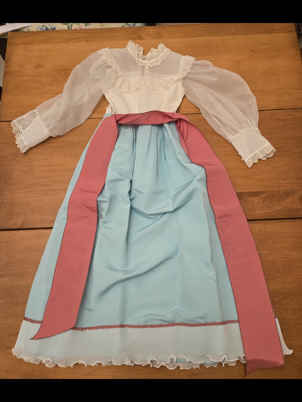 Vintage-inspired White Sheer Sleeve Dress with Blue Skirt and Pink Sash